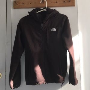 brown woman’s north face jacket